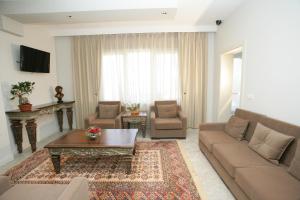 a living room with a couch and a coffee table at Hotel Vila 60 in Tirana