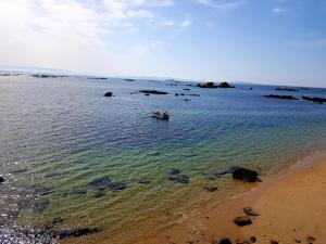 a person in a boat in the water on the beach at casazul in San Pedro