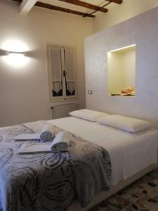 a bedroom with a bed with towels on it at Ca' Zuliani Rooms in Chioggia