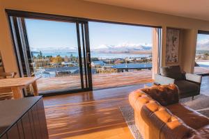 a living room with a couch and a large window at The View Lake Tekapo in Lake Tekapo