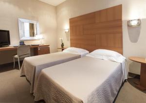 Postel nebo postele na pokoji v ubytování Hotel Cora