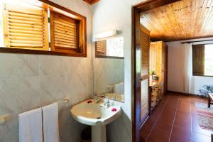 a bathroom with a sink and a toilet in it at La Villa Mille Etoiles in Baie Sainte Anne