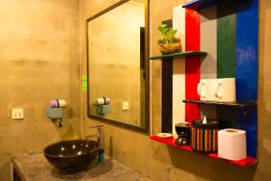 a bathroom with a sink and a mirror at La Niche D'angkor Boutique Hotel in Siem Reap