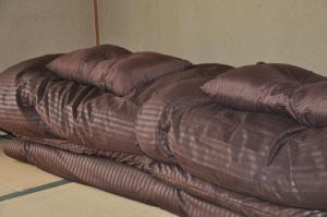 two pillows sitting on top of a comforter at Tuktuk House in Kawagoe +48 photos