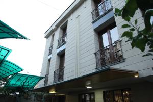 a building with balconies on the side of it at Daniel Boutique Hotel in Yerevan