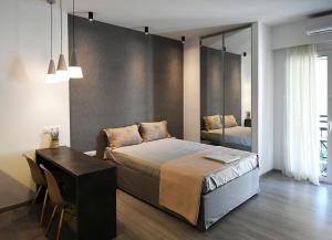 a bedroom with a bed and a desk and a mirror at Nest Apartment in Athens