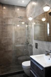 a bathroom with a shower and a toilet and a sink at Nest Apartment in Athens