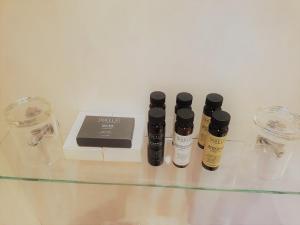 three bottles of essential oils sitting on a glass table at La Baia Hotel - Sea Views Over North Bay - Free Parking - Room Only in Scarborough