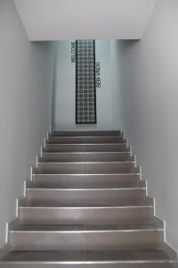 a set of stairs in a building with a window at StayInn City - Póvoa de Varzim in Póvoa de Varzim