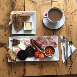 a plate of breakfast food with a cup of coffee at Crown and Anchor in Dundrennan