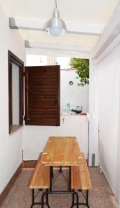 a wooden table in a room with a window at Residence Lion in San Vito lo Capo