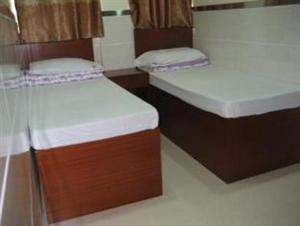 Cama o camas de una habitación en E-Dragon Hotel 一龙酒店