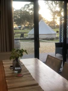 a table with a view of a white tent at Coonawarra Ensuite Unit C in Coonawarra