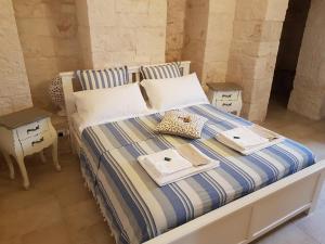 Postel nebo postele na pokoji v ubytování Trulli Petra Chiara + 37 fotografií