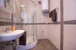 a bathroom with a shower and a sink and a sink at Apartments Casa Toni Dubrovnik in Dubrovnik
