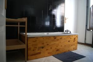 a bathroom with a sink and a bath tub at Gites les Grandes Gouttes in Le Syndicat +18 photos