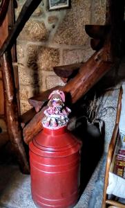 a red fire hydrant sitting on top of a wooden table at Casa das Freiras in Marialva