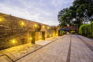 a stone wall with lights on the side of it at VITS Shalimar, Ankleshwar in Ankleshwar