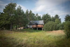 a house in the middle of a field with trees at Las Hamernia's in Hamernia