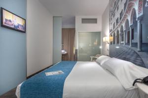 Postel nebo postele na pokoji v ubytování AACR Hotel Monteolivos