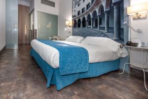Postel nebo postele na pokoji v ubytování AACR Hotel Monteolivos