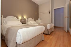 Postel nebo postele na pokoji v ubytování AACR Hotel Monteolivos