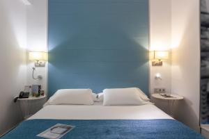 Postel nebo postele na pokoji v ubytování AACR Hotel Monteolivos