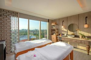 a room with three beds and a sink and a window at Pan Pacific Yangon in Yangon