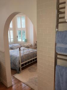 a bedroom with a bed and a window at Raymonds in Douglas