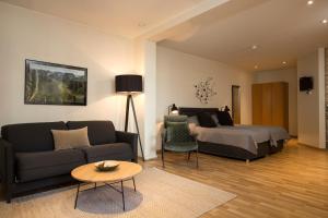 a living room with a couch and a bed at Hotel Fr&oacute;n in Reykjav&iacute;k