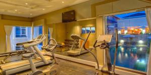 a gym with two tread machines and a large window at Eka Hotel Nairobi in Nairobi
