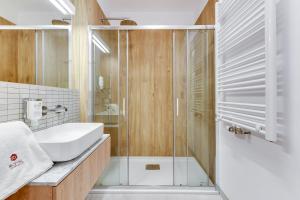 a bathroom with a sink and a shower at Browar Gdanski Budget by Renters in Gdańsk