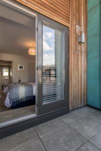 a sliding glass door leading to a bedroom with a bed at Exclusive Dublin City Penthouse in Dublin