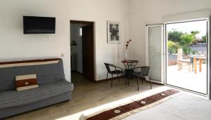 a living room with a couch and a table with chairs at Cortijo Oro Verde B&B in Tabernas