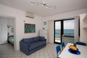 a living room with a couch and a table at Residence Le Dune Club in Varigotti