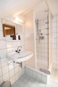 a white bathroom with a sink and a shower at Appartement Haus Moser in Sankt Michael im Lungau