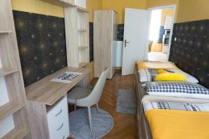 a dorm room with two bunk beds and a desk at Luxory Apartment The Soul Of City in Maribor