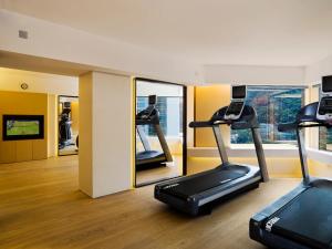 a gym with two treadmills and a mirror at Upper House Hong Kong in Hong Kong +45 photos