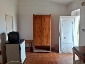 a living room with a door and a television and a room with a door gmaxwell at Sina Star Camp in Nuweiba