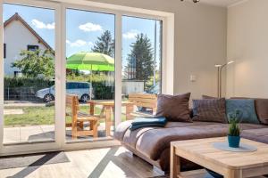 a living room with a couch and a table at Haus Sternstunden in Bansin