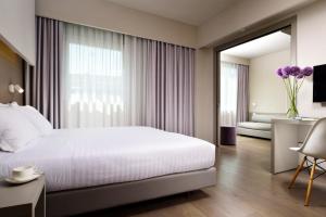 Postel nebo postele na pokoji v ubytování Hotel Glance In Florence