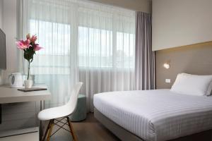 Postel nebo postele na pokoji v ubytování Hotel Glance In Florence