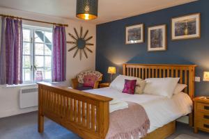 a bedroom with a bed and a clock on the wall at 4 Bell Lodge, Thorpeness in Thorpeness