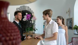 a man and a woman standing at a table at Villa Corallium in Praiano +120 photos