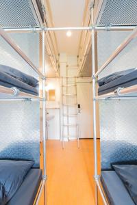 a room with two bunk beds and a ladder at Jorplace Boutique Hostel in Scheveningen