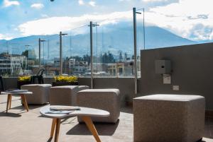 a room with tables and chairs and a view of a city at Hotel Plaza Carnaval in Pasto