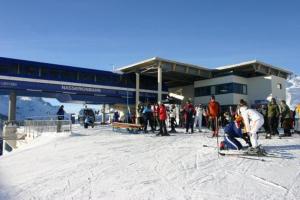 a group of people standing in the snow at a ski lodge at Parseierblick in Sankt Anton am Arlberg