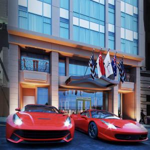 two red cars parked in front of a building at Orchard Garden Hotel in San Francisco