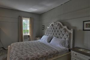 a bedroom with a large bed and a window at Charlevoix House in Charlevoix