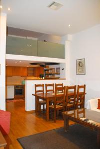 a kitchen and dining room with a table and chairs at Luxurious Loft with Jacuzzi in Heraklio Town